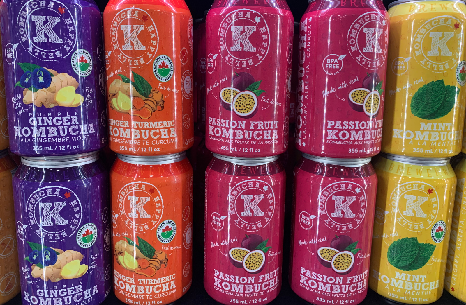 happy belly kombucha assorted flavors cans in a grocery shelf or rack banner