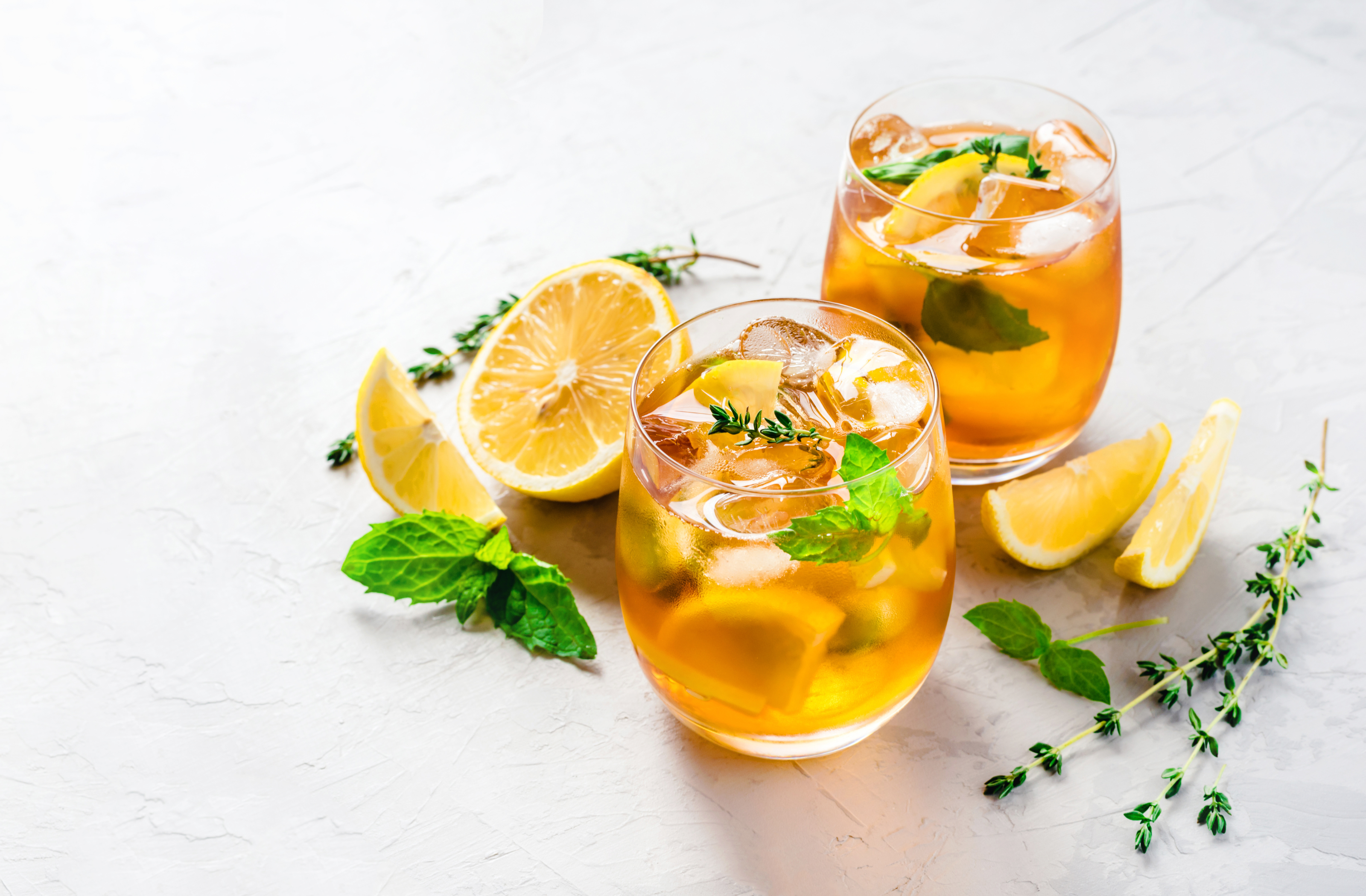 happy belly kombucha iced teas in two glasses with lemon