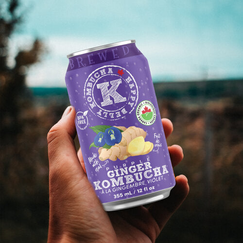 holding a can of happy belly kombucha purple ginger kombucha brewed