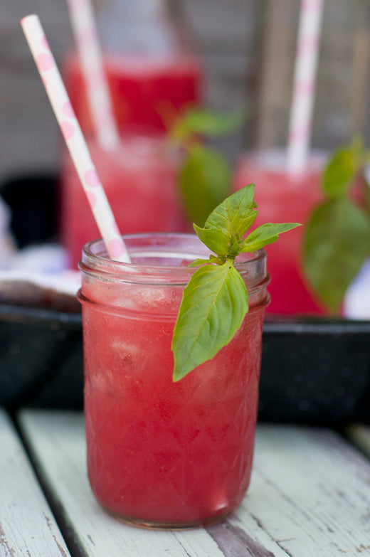 strawberry cocktail glass with straw and mint